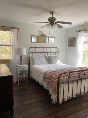 a bedroom with a bed and a ceiling fan at Mountain Creek Lodge in Maggie Valley