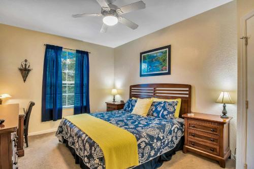 a bedroom with a bed and a ceiling fan at Magical Adventure Condo w Waterpark near Disney No Resort Fees in Orlando