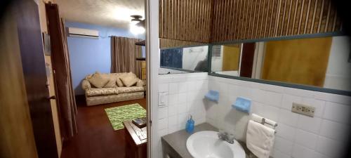 a bathroom with a sink and a mirror at Garden In Paradise in Nassau
