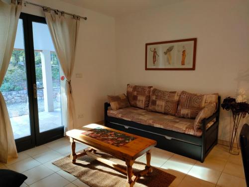 a living room with a couch and a coffee table at O'fildl'eau gîte in Sillans-la Cascade
