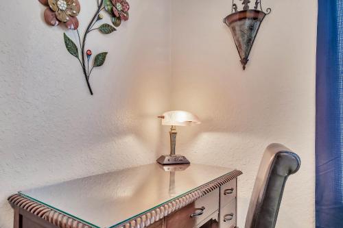 a table with a lamp on top of a wall at Magical Adventure Condo w Waterpark near Disney No Resort Fees in Orlando