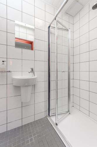 a bathroom with a shower and a sink at Wardonia Hotel Kings Cross in London