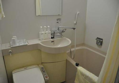 a bathroom with a sink and a toilet and a tub at Kadoma Public Hotel/ Vacation STAY 33571 in Kadoma