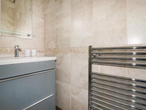 a bathroom with a sink and a shower at Garden View in Newquay