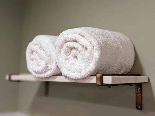 two towels sitting on a shelf in a bathroom at Stanton House Inn in Greenwich
