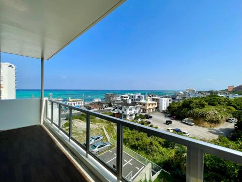 a balcony with a view of the ocean at Coral Palace Onna by Sunset Avenue in Onna