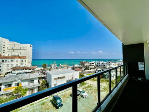 a balcony with a view of the ocean at Coral Palace Onna by Sunset Avenue in Onna