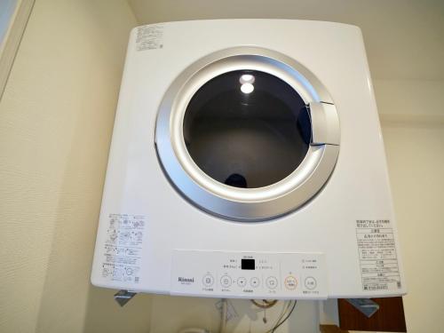 a washing machine is hanging on a wall at Coral Palace Onna by Sunset Avenue in Onna