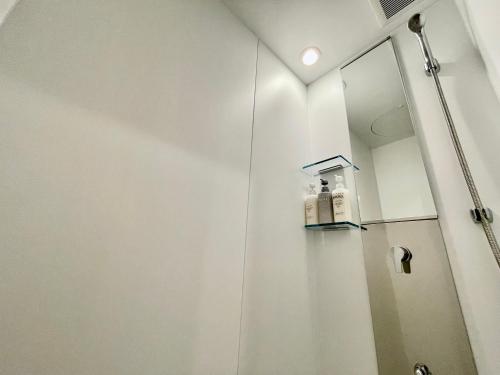 a bathroom with a shower with a mirror at Coral Palace Onna by Sunset Avenue in Onna
