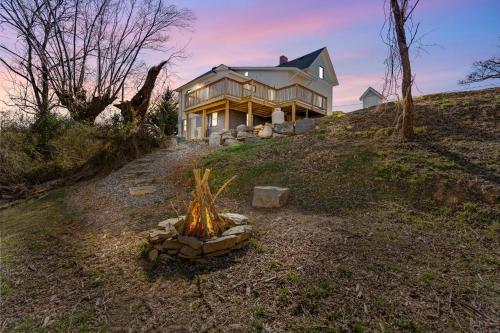 a house on top of a hill with a fire pit at *NEW! The Rectory, King Bed, Home Theater, Deck, BBQ, Fire Pit in Marshall