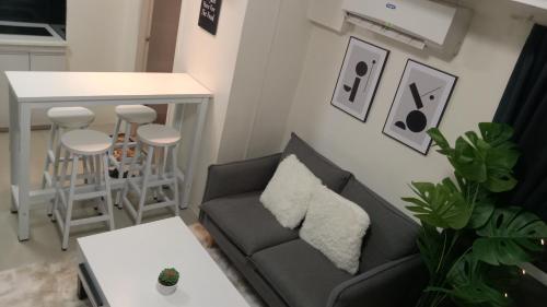 a living room with a couch and a table at A2J Luxury BGC 2BR Loft Near Malls, Burgos Circle in Manila