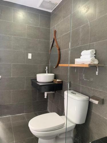 a bathroom with a toilet and a sink at K73 De HOUSE in Danang