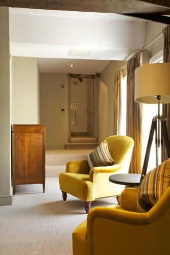a living room with two chairs and a table at Kings Head in Cirencester