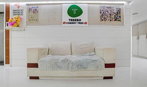 a chair with a blanket on it in a room at Treebo Cherry Tree in Indore