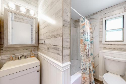 a bathroom with a sink and a toilet and a window at Montego Bay 120 in Ocean City