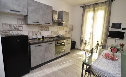 a kitchen with stainless steel appliances and a dining table at BLhouse in Turin
