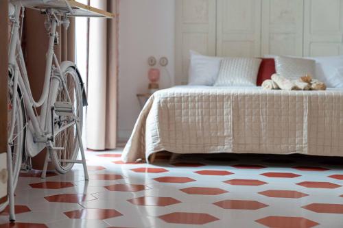 a bedroom with a bed with a bicycle next to it at Suitetti Camere&Relax in San Nicola Arcella