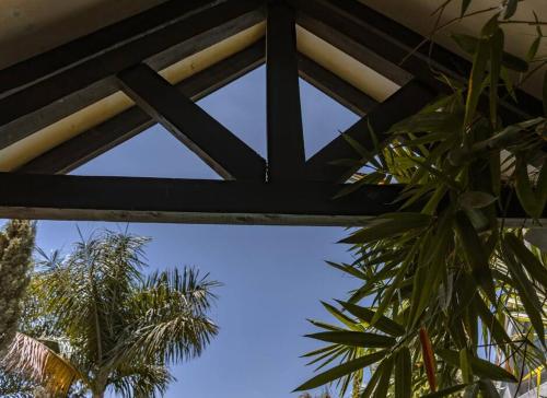 a view of the sky from underneath a roof at The Annex at 64 : Cozy, rustic cottage/treehouse in Nairobi