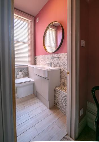 a bathroom with a sink and a mirror at Vale House in Belvoir