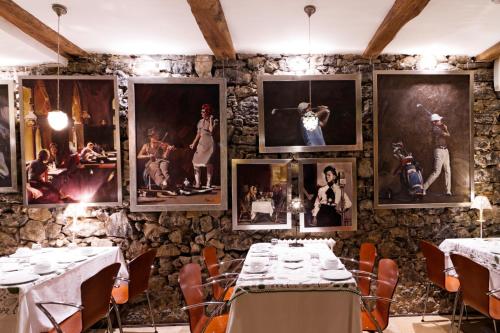a room with tables and pictures on the wall at Mar Del Sueve in Colunga