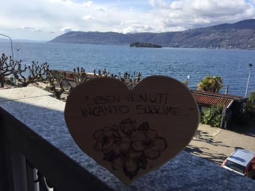 a heart with writing on it next to a body of water at Incanto Sublime in Verbania
