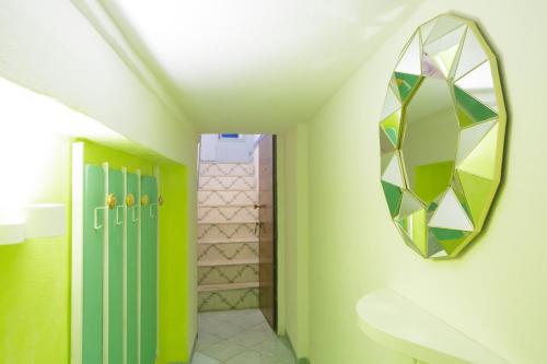 a bathroom with a mirror on the wall at ti Porto al Centro Unforgettable Moments in Salerno