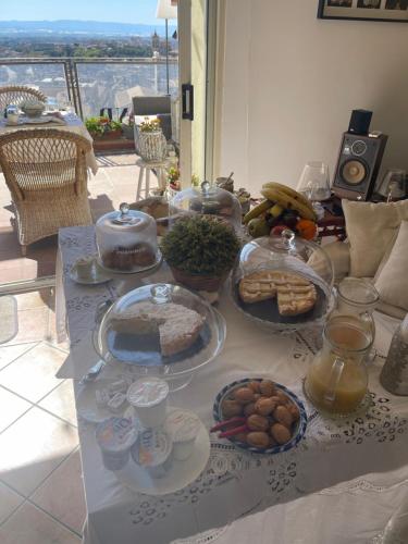 a table with many plates of food on it at Casa tipica siciliana patronale home BedandBreakfast TreMetriSoprailCielo Camere con vista, colazione interna in terrazzo panoramico in Caltagirone