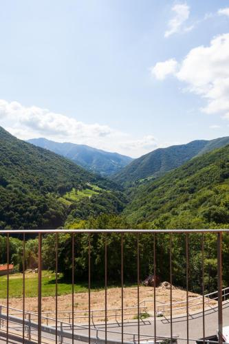 a view of the mountains from a balcony at Ostello Scudellate MONTE GENEROSO in Scudellate