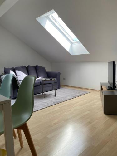 a living room with a couch and a skylight at Das Bergl in Rosegg