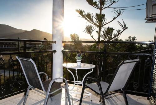a patio with two chairs and a table on a balcony at Sunny Apt at Regina Apartments in Zakynthos Town