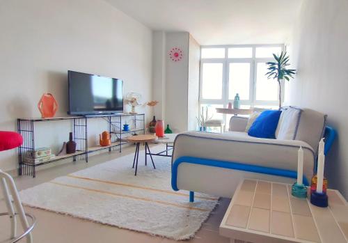 a living room with a couch and a tv at A casa da sardiña. Unha parada no Atlántico in Fisterra