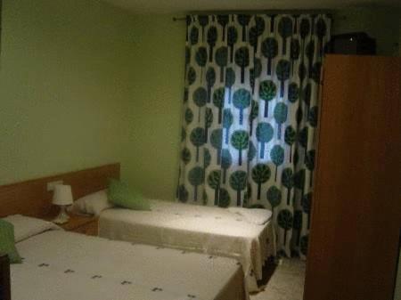 Postel nebo postele na pokoji v ubytování Hostal Emilio Barajas