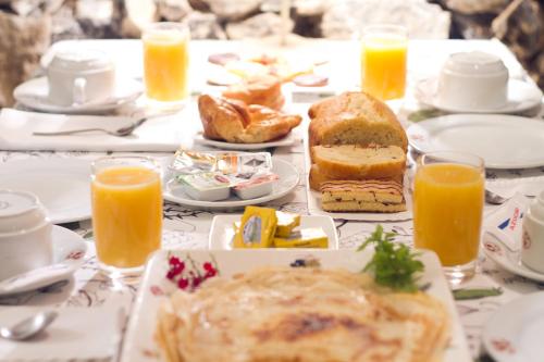 a table topped with breakfast foods and orange juice at Mar Del Sueve in Colunga