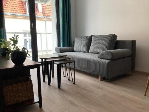 a living room with a couch and a table at Apartament Wrzeszcz, Kamienice Kołłątaja in Gdańsk
