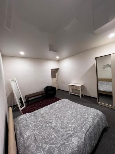 a bedroom with a large bed and a mirror at Kilikia, Centre in Yerevan