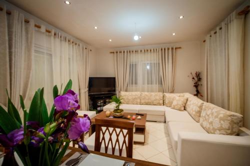 a living room with a couch and a table at Mirimar Apartments in Alikanas