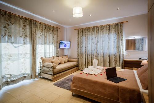 a living room with a bed and a couch at Mirimar Apartments in Alikanas