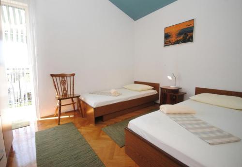 a living room with two beds and a window at Apartment Rina - 200 m from beach in Okrug Donji