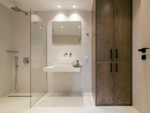 a bathroom with a sink and a shower at Chrysothemis Villas in Pigadhákia