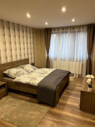 A bed or beds in a room at Anita Apartman Miskolctapolca