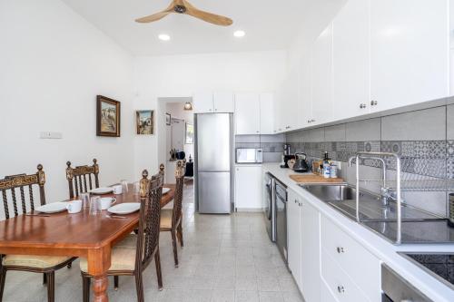 a kitchen with a wooden table and a dining room at To Hani - Kamara Maisonette in Nicosia
