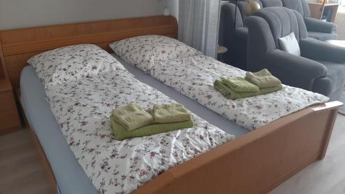 a bed with two pillows on top of it at Ferienwohnung Schattschneider in Burgtiefe auf Fehmarn 