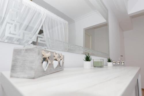 a bathroom with a white counter with a mirror at ALPASIO RENTALS in Galaţi