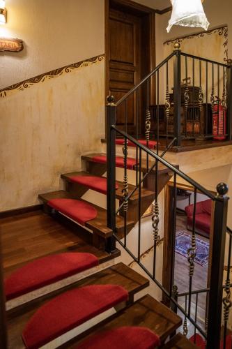 a set of stairs with red cushions at Archontiko Mesohori Meteora in Kalabaka