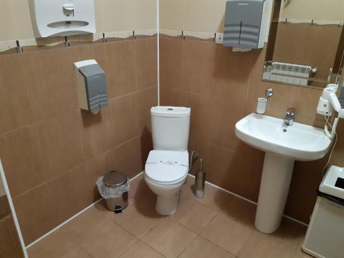 a bathroom with a toilet and a sink at In hotel in Kamianets-Podilskyi