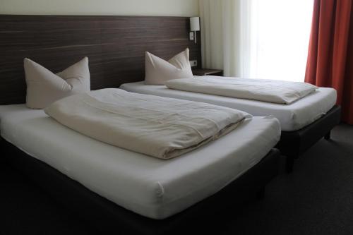 Cama o camas de una habitación en Hotel Weissach Am Neuenbühl