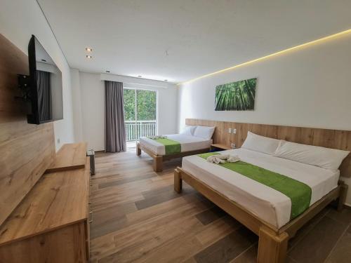 Postel nebo postele na pokoji v ubytování Hotel Monte Bello