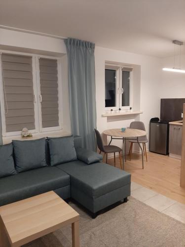 a living room with a couch and a table at Apartament Zamkowy in Malbork