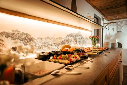 a buffet line with fruits and vegetables on it at Gästehaus Mathies in Mittelberg