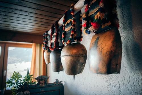 a group of copper pots hanging on a wall at Gästehaus Mathies in Mittelberg